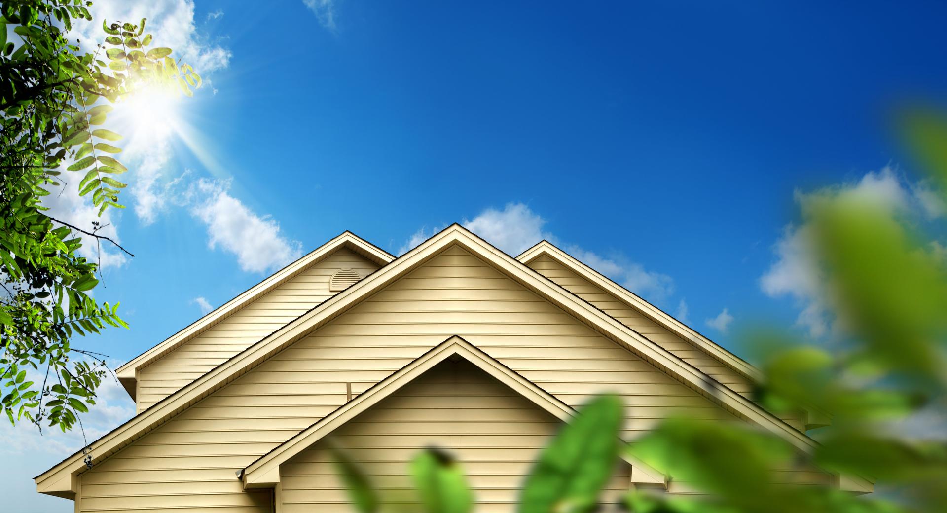 family home exterior over sunny blue sky