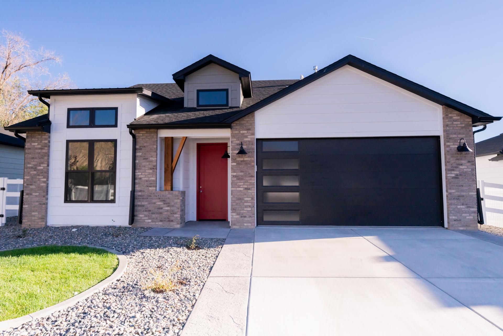 Front Exterior Brand New Trendy Upscale Home Ready for Sale on a Sunny Day