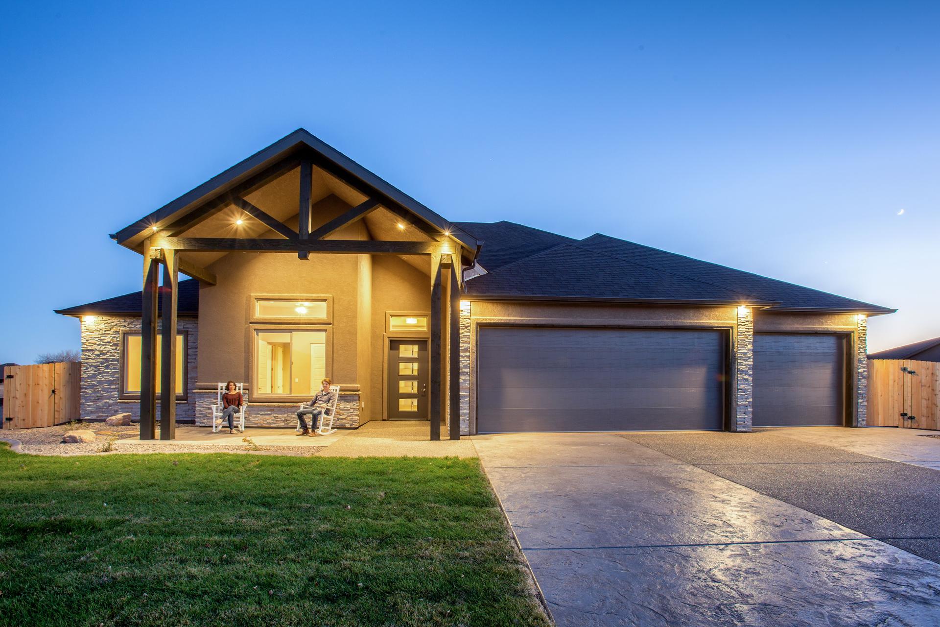 Young Couple Sitting on Porch of New Home at Twilight