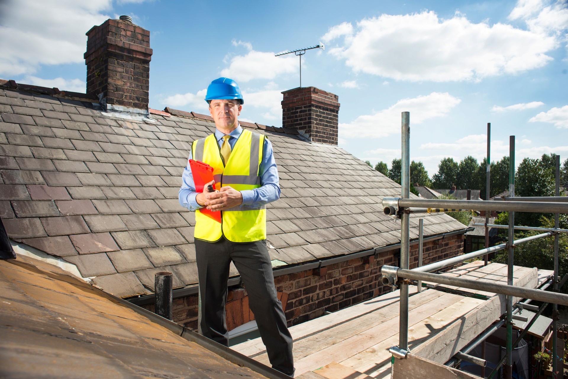 building inspector assesses slate roof condition